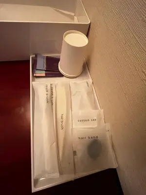 a white bag with a cup on top of it at Hills Hotel Gotanda in Tokyo