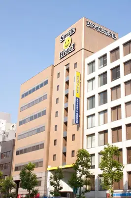 a building with a hotel sign on top of it at Smile Hotel Tokyo Nihonbashi in Tokyo