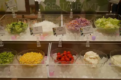 a display case with bowls of different types of food at Smile Hotel Tokyo Nihonbashi in Tokyo