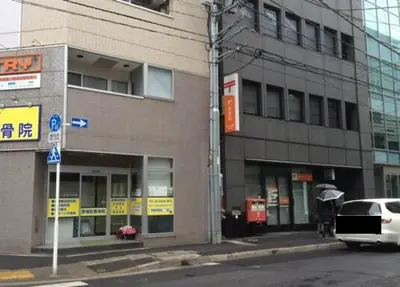 a white car parked in front of a building at Smile Hotel Tokyo Nihonbashi in Tokyo