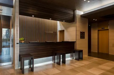 a large piano in a lobby with two benches at Hotel Route-Inn Grand Tokyo Asakusabashi in Tokyo