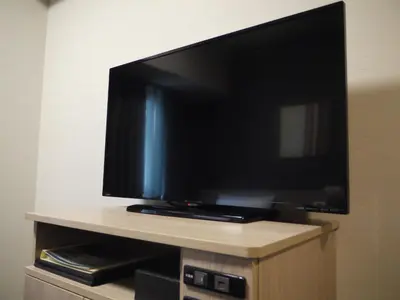 a flat screen tv sitting on top of a cabinet at Hotel Route-Inn Grand Tokyo Asakusabashi in Tokyo