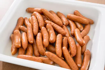 a white container filled with lots of sausages at Hotel Route-Inn Grand Tokyo Asakusabashi in Tokyo