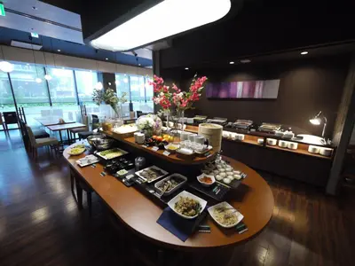 a table with food on it in a restaurant at Hotel Route-Inn Grand Tokyo Asakusabashi in Tokyo
