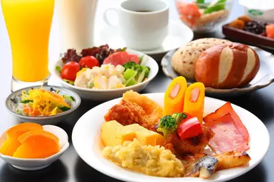 a table topped with plates of breakfast foods and drinks at Hotel Route-Inn Grand Tokyo Asakusabashi in Tokyo