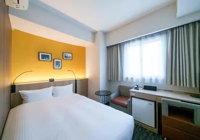 a hotel room with a bed and a television at Smile Hotel Tokyo Asagaya in Tokyo