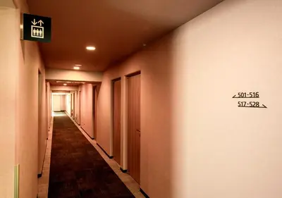 a hallway with a sign on the wall at Smile Hotel Tokyo Asagaya in Tokyo