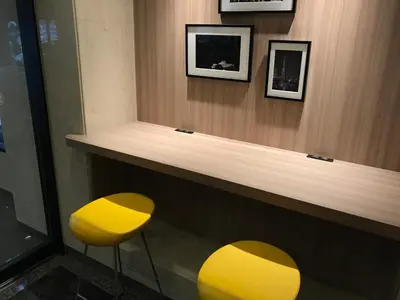 two yellow stools sitting at a counter in a room at Smile Hotel Tokyo Asagaya in Tokyo