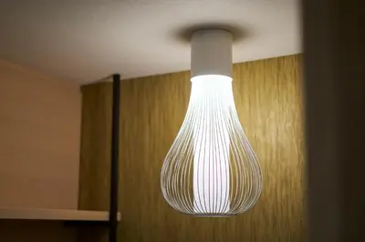 a large white light hanging from a ceiling at HOTEL 1899 TOKYO in Tokyo