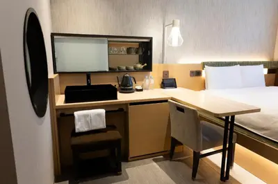 a hotel room with a desk and a bed at HOTEL 1899 TOKYO in Tokyo