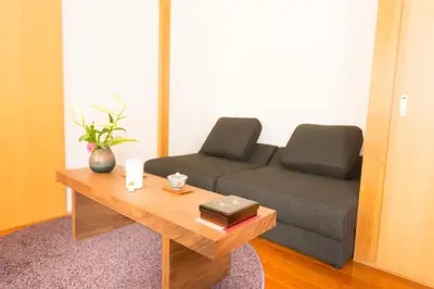 a living room with a couch and a coffee table at K&K Apartment Kita-Akabane #301 in Tokyo