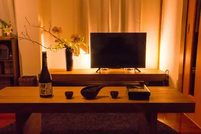 a bottle of wine and a television on a table at K&K Apartment Kita-Akabane #301 in Tokyo