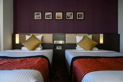 two beds in a hotel room with purple walls at HOTEL MYSTAYS Ueno East in Tokyo