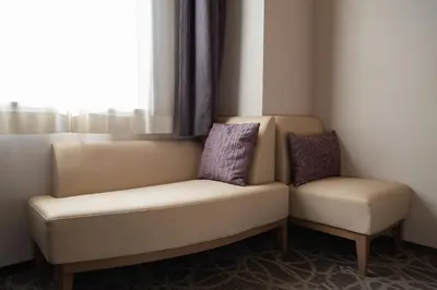 two chairs and a couch in a room with a window at HOTEL MYSTAYS Ueno East in Tokyo