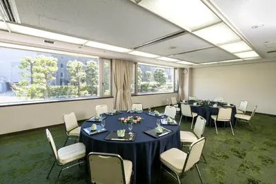 a conference room with tables and chairs and large windows at Chisun Hotel Hamamatsucho in Tokyo
