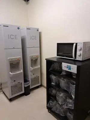 a room with two refrigerators and a microwave on a counter at Chisun Hotel Hamamatsucho in Tokyo