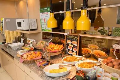 a buffet with bowls of food on a counter at Super Hotel Tokyo Otsuka in Tokyo