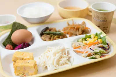 a tray with a plate of food on a table at Super Hotel Tokyo Otsuka in Tokyo