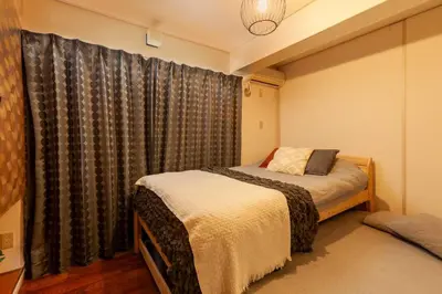 a bedroom with two beds and a window at Premier suite MEGURO Tokyo in Tokyo