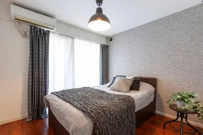 a bedroom with a bed and a large window at Premier suite MEGURO Tokyo in Tokyo