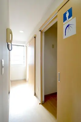 an empty hallway with a door to a room at Juyoh Hotel in Tokyo