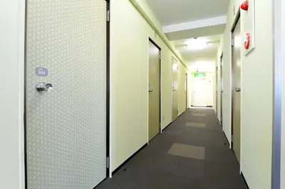a corridor of corridors in an office building at Juyoh Hotel in Tokyo
