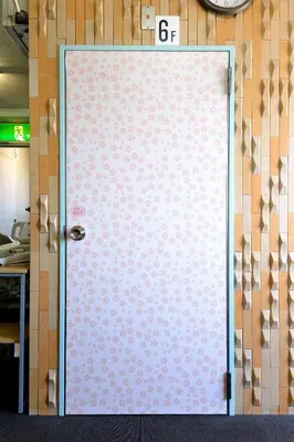 a door with a sign on top of it at Juyoh Hotel in Tokyo