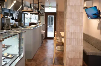 a kitchen with a counter and a dining room at Juyoh Hotel in Tokyo