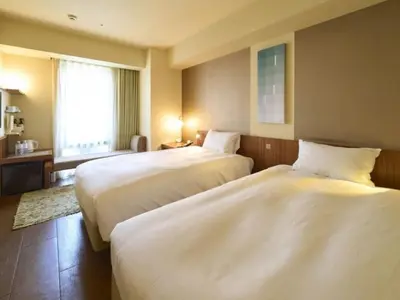 a hotel room with two beds and a window at Hotel Resol Ikebukuro in Tokyo
