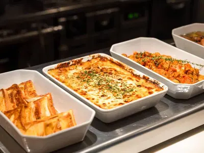 three dishes of food on a counter with waffles at Hotel Resol Ikebukuro in Tokyo