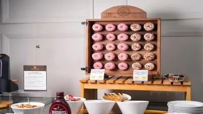 a display of pink donuts on a shelf at Hotel Monterey Ginza in Tokyo