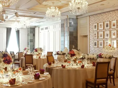 a banquet room with tables and chairs with chandeliers at Hotel Monterey Ginza in Tokyo