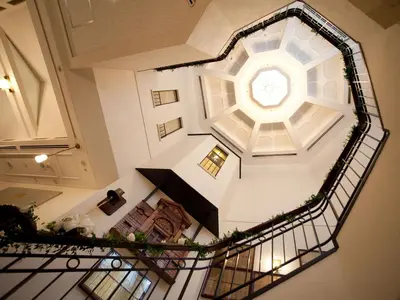an overhead view of a spiral staircase with a clock at Hotel Monterey Ginza in Tokyo