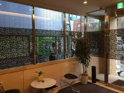 a room with a table and chairs and a window at Hotel U in Tokyo