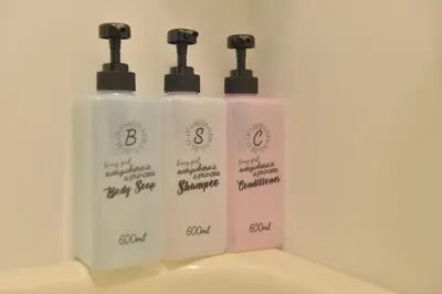a group of three white bottles of detergent at Mervielle Ueno in Tokyo