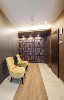 a waiting room with two chairs and a book shelf at Hotel SAILS in Tokyo