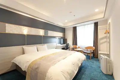 a hotel room with a large bed and a desk at Hotel Tokyo Garden Palace in Tokyo