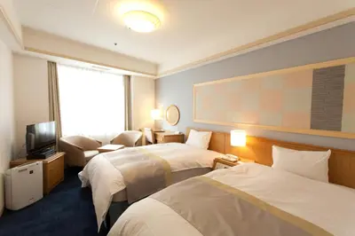 a hotel room with two beds and a television at Hotel Tokyo Garden Palace in Tokyo