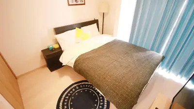 a small bedroom with a bed and a window at Uhome Kanda Hotel in Tokyo