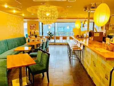a restaurant with a bar with green chairs and tables at Tokyo Plaza Hotel in Tokyo