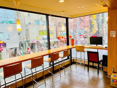 a restaurant with a bar with chairs and a monitor at Tokyo Plaza Hotel in Tokyo