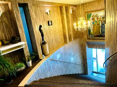 a spiral staircase in a building with a statue at Tokyo Plaza Hotel in Tokyo
