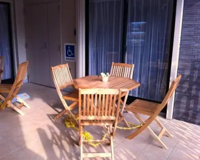 a wooden table and four chairs on a patio at Hotel Palace Japan in Tokyo