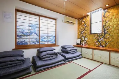 a room with cushioned chairs in a room with a window at Luxury Guest House in Tokyo Shinjuku in Tokyo