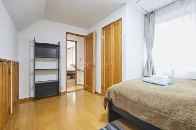 a bedroom with a large bed and a window at Luxury Guest House in Tokyo Shinjuku in Tokyo