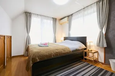 a bedroom with a bed and a large window at Luxury Guest House in Tokyo Shinjuku in Tokyo