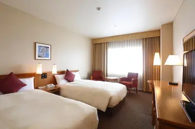 a hotel room with two beds and a desk at Dai-ichi Hotel Ryogoku in Tokyo