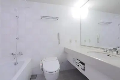 a bathroom with a toilet and a tub and a sink at Dai-ichi Hotel Ryogoku in Tokyo