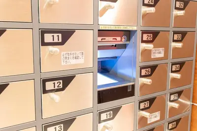 a row of lockers with a laptop in them at Hotel Keihan Asakusa in Tokyo