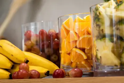 a bunch of fruit in glass vases on a table at Hotel Keihan Asakusa in Tokyo